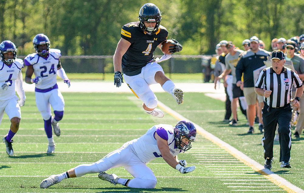 Dylan Hecker leaps a UW-Whitewater defender.