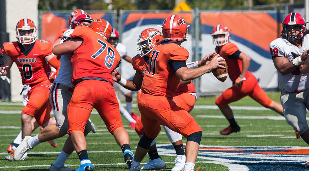 Carroll quarterback, pictured from behind, looking downfield. (Carroll athletics file photo)