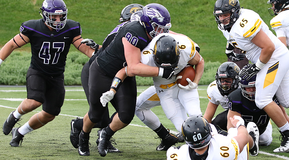 Dalton Heckel of UW-Whitewater wraps up UW-Oshkosh ballcarrier JP Peerenboom. (Photo by Daryl Tessmann, d3photography.com)